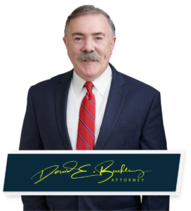 Concord Car Accident Attorney David Buckley poses for headshot with a signature below 